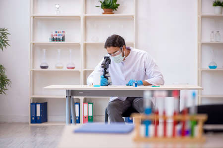 Young male chemist working at the labの写真素材