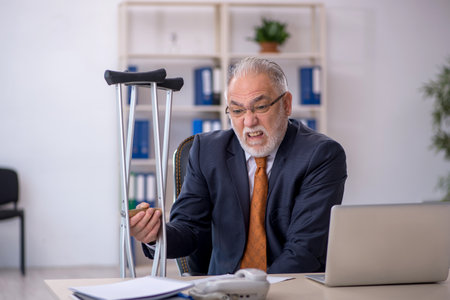 Old male employee after accident at workplaceの写真素材