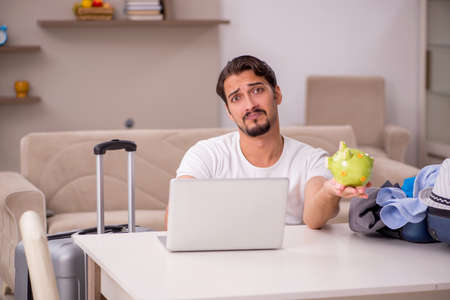 Young man preparing for trip at homeの写真素材