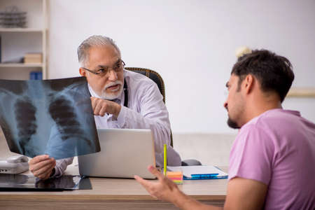 Young male patient visiting old male doctor radiologist