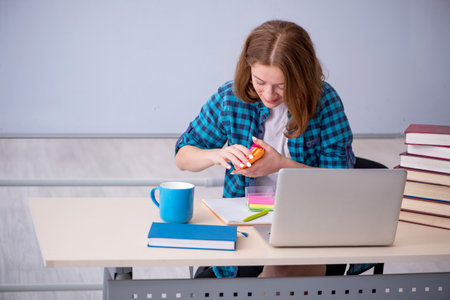 Young female student preparing for exams in the classroomの写真素材