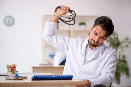 Young male doctor working in the clinicの写真素材