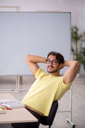 Young male student preparing for exams in the classroomの写真素材