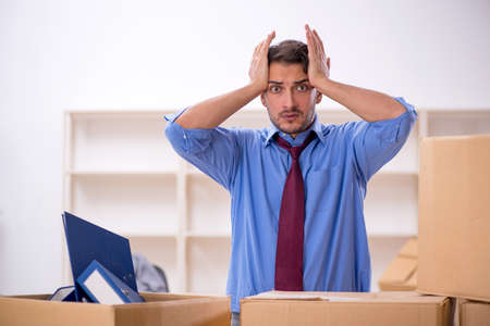 Young male employee in office relocation concept