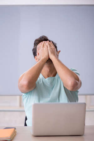 Young male student in telestudying conceptの写真素材