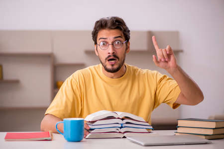 Young male student preparing for exams at homeの写真素材