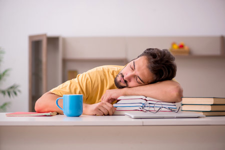 Young male student preparing for exams at homeの写真素材