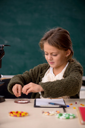 Young little girl chemist in drugs synthesis conceptの写真素材