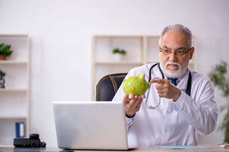 Old male doctor in retirement conceptの写真素材