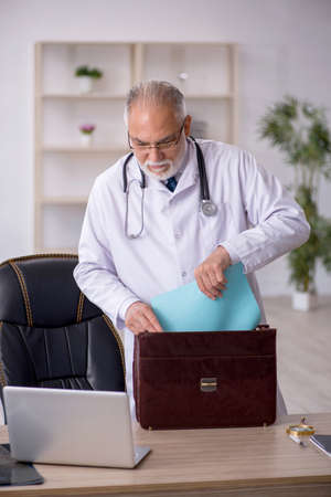 Old male doctor working in the clinicの写真素材