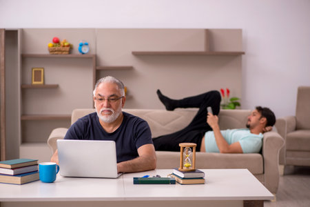 Old grandfather in distant learning concept during pandemicの写真素材