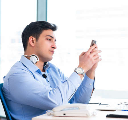 Male call-center operator in business concept