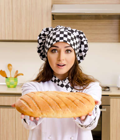 Young female baker working in kitchen