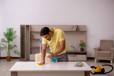 Young man doing housework at home