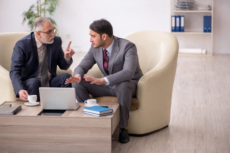 Two businessmen discussing project at workplaceの写真素材