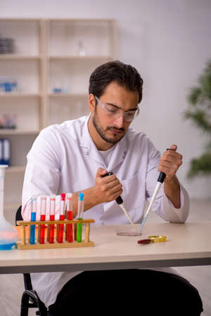 Young male chemist working at the labの写真素材