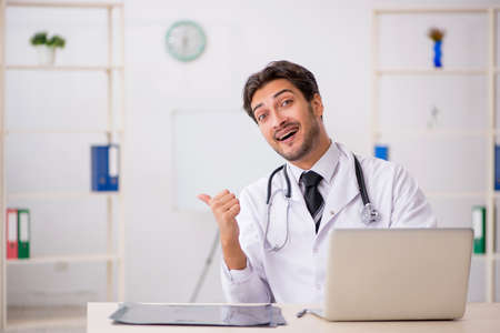 Young male doctor working in the clinicの写真素材