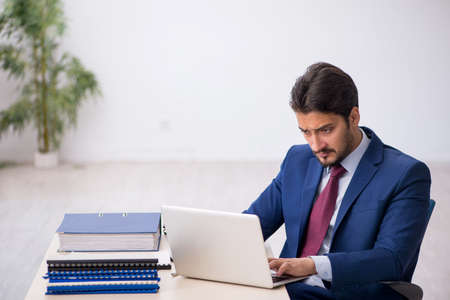 Young male employee working at workplaceの写真素材