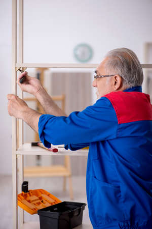 Old male carpenter working indoorsの写真素材