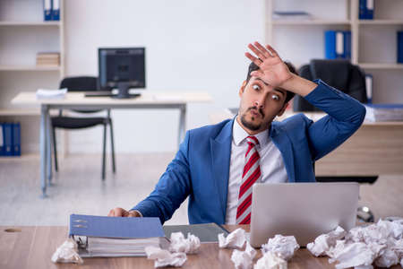 Young male employee in brainstorming conceptの写真素材