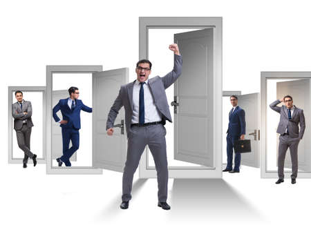 Businessman in uncertainty concept with many doorsの写真素材