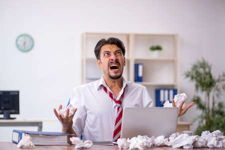 Young male employee in brainstorming conceptの写真素材