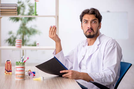 Young male dentist working in the clinicの写真素材