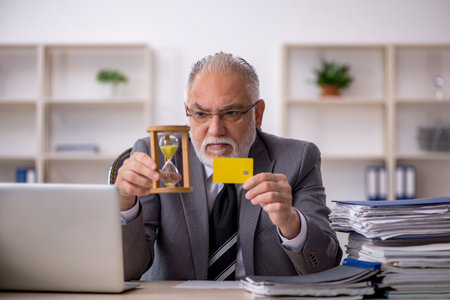 Old male employee in time management concept