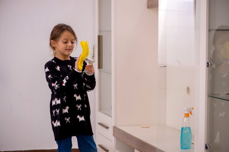 Young little girl doing housework at home