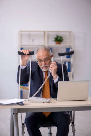 Old male employee after accident at workplaceの写真素材