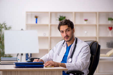 Young male doctor working in the clinicの写真素材