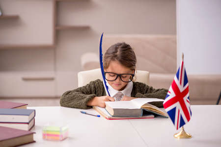 Young little girl studying english language at homeの写真素材