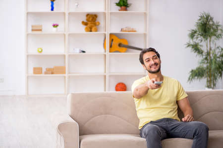 Young man sitting at home during pandemicの写真素材