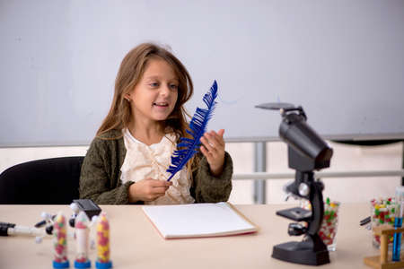 Young little girl chemist in drugs synthesis conceptの写真素材