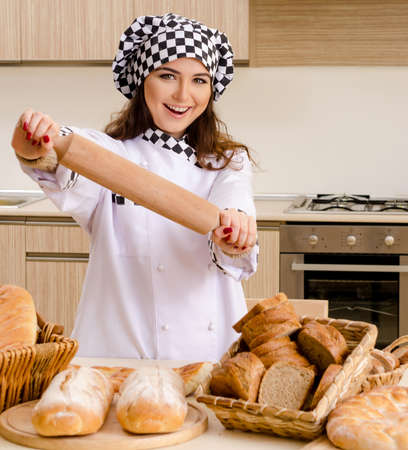 Young female baker working in kitchen
