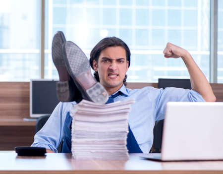 Young employee unhappy with excessive workの写真素材