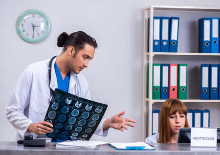 Two doctors working at the reception in the hospitalの写真素材