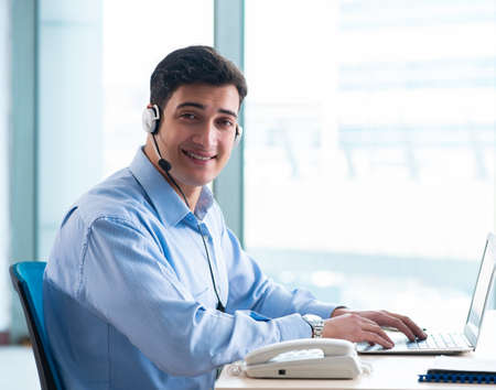 Male call-center operator in business concept