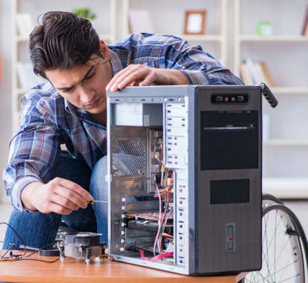 Computer repairman on wheelchair working