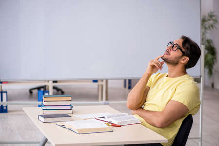 Young male student preparing for exams in the classroomの写真素材