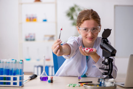 Young female chemist in drugs synthesis conceptの写真素材