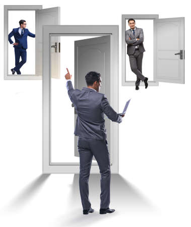 Businessman in uncertainty concept with many doorsの写真素材