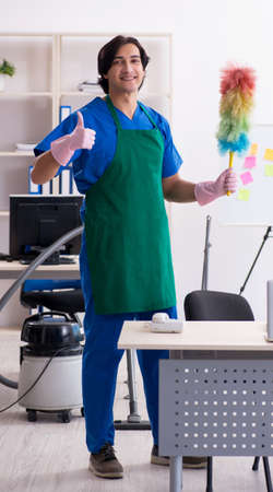 Male handsome professional cleaner working in the office