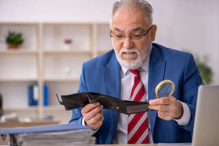 Old male employee in remuneration conceptの写真素材
