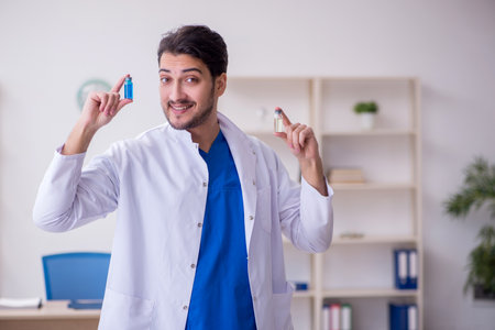 Young male doctor in vaccination conceptの写真素材