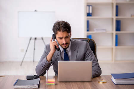 Young male employee sitting in the officeの写真素材