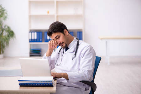 Young male doctor working in the clinicの写真素材