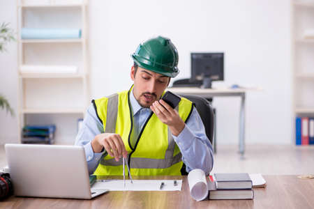 Young male architect working in the officeの写真素材