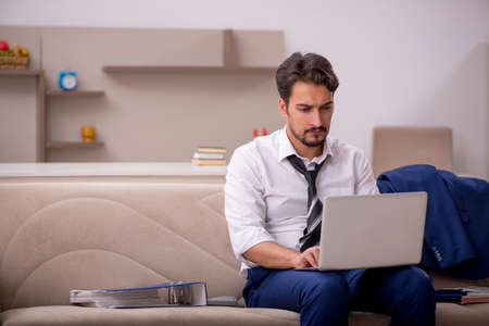 Young male employee working from home during pandemicの写真素材