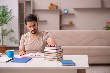 Young male student studying at home during pandemicの写真素材